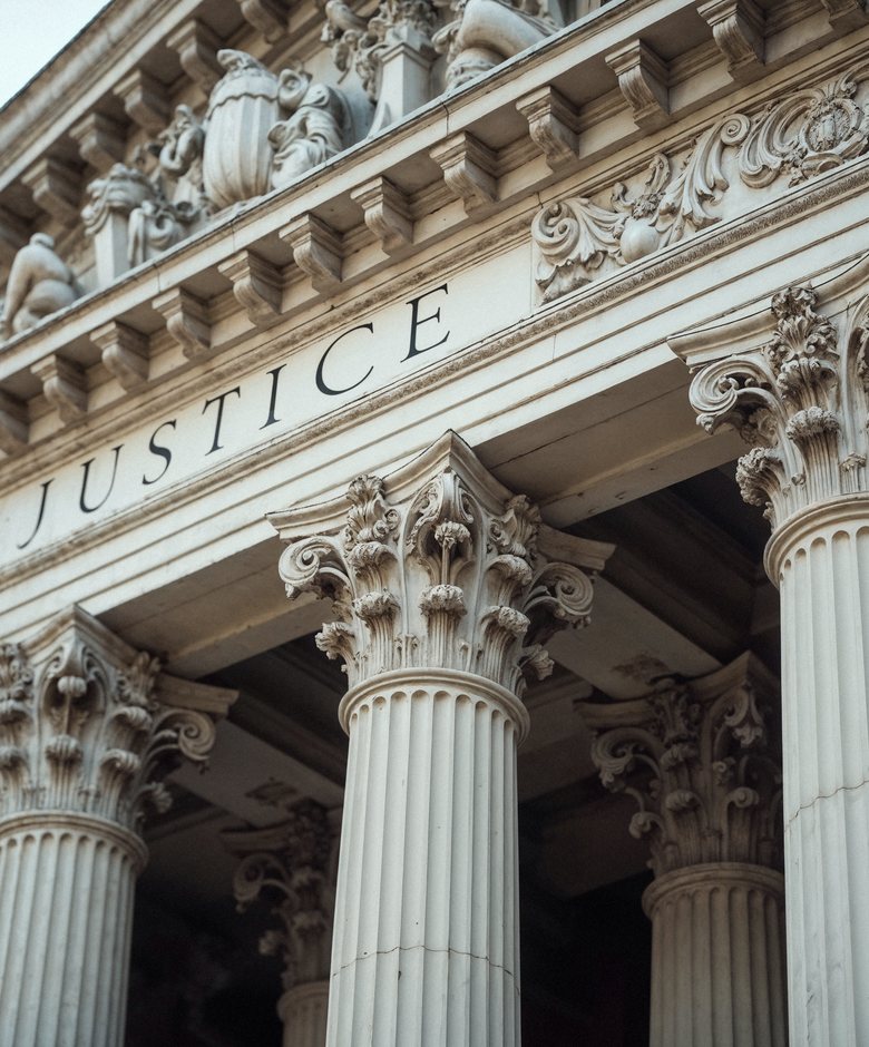 Courthouse facade bearing the word Justice